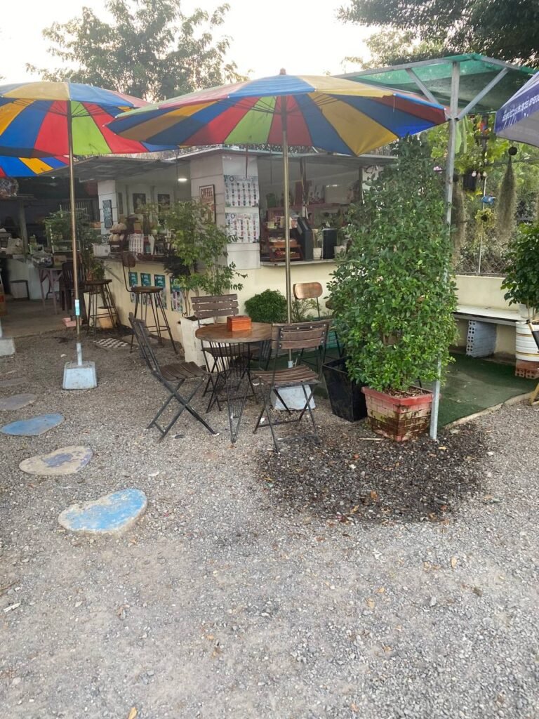 Outdoor coffee stall The Press Day Coffee with colorful umbrellas and seating.